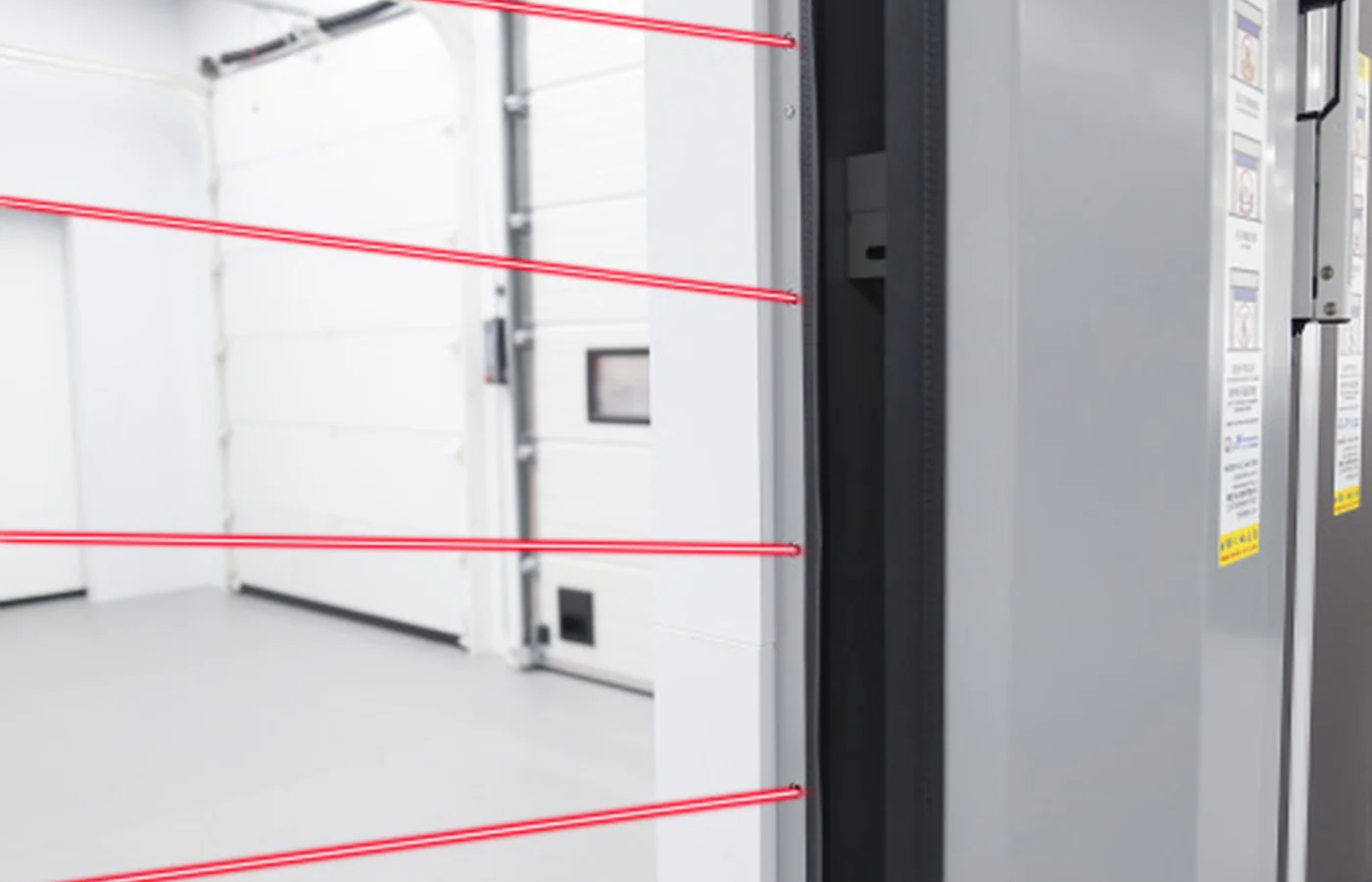 Multi-beam safety light curtain protecting an industrial door opening