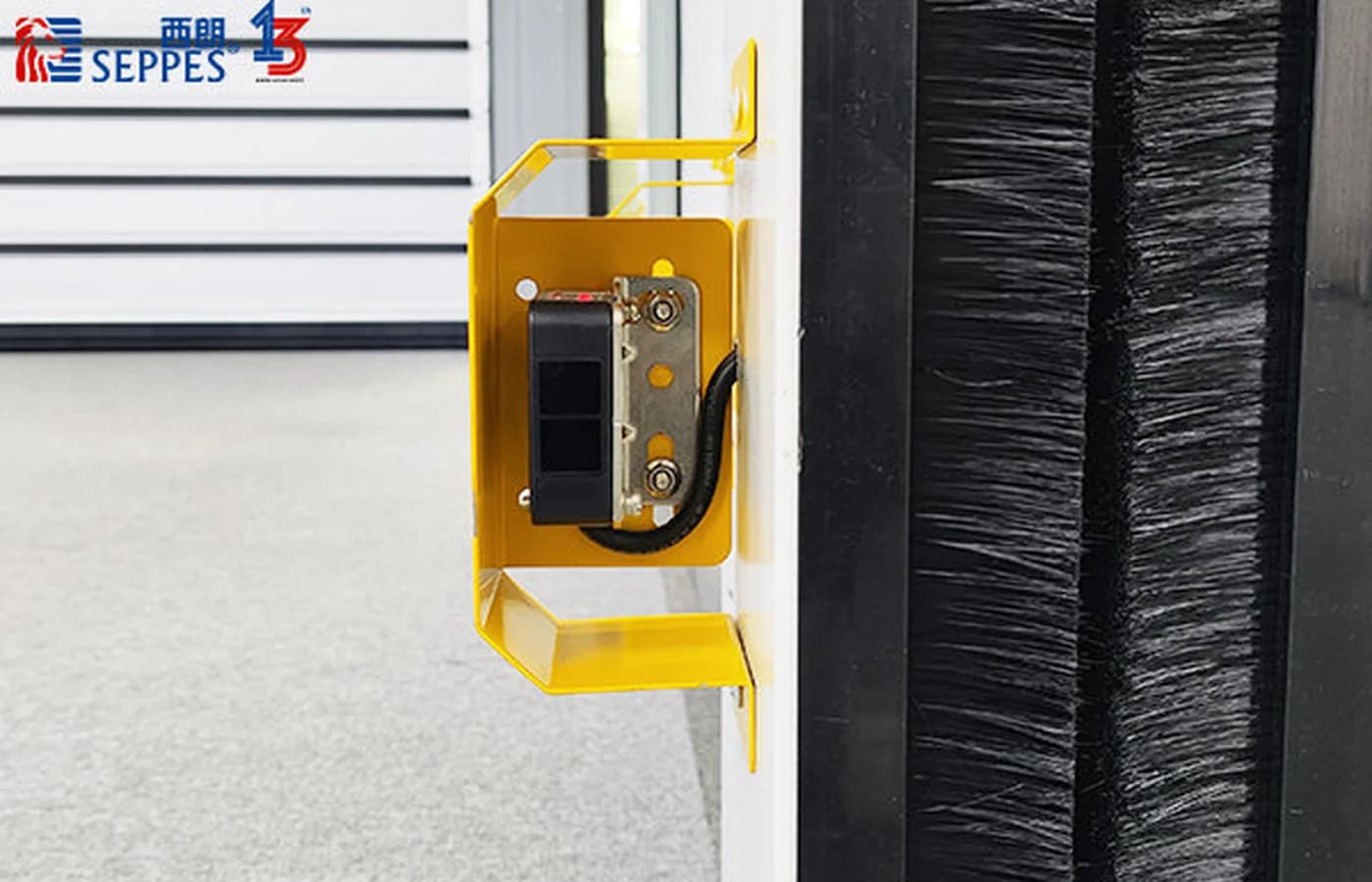 Protected infrared photocell mounted beside a SEPPES high-speed door guide