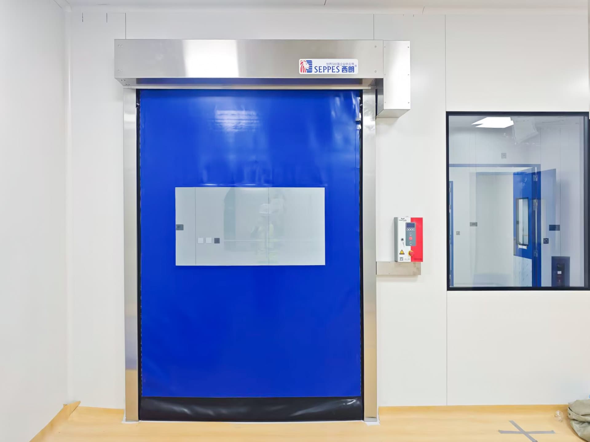Blue SEPPES high-speed door installed at a clean production room entrance
