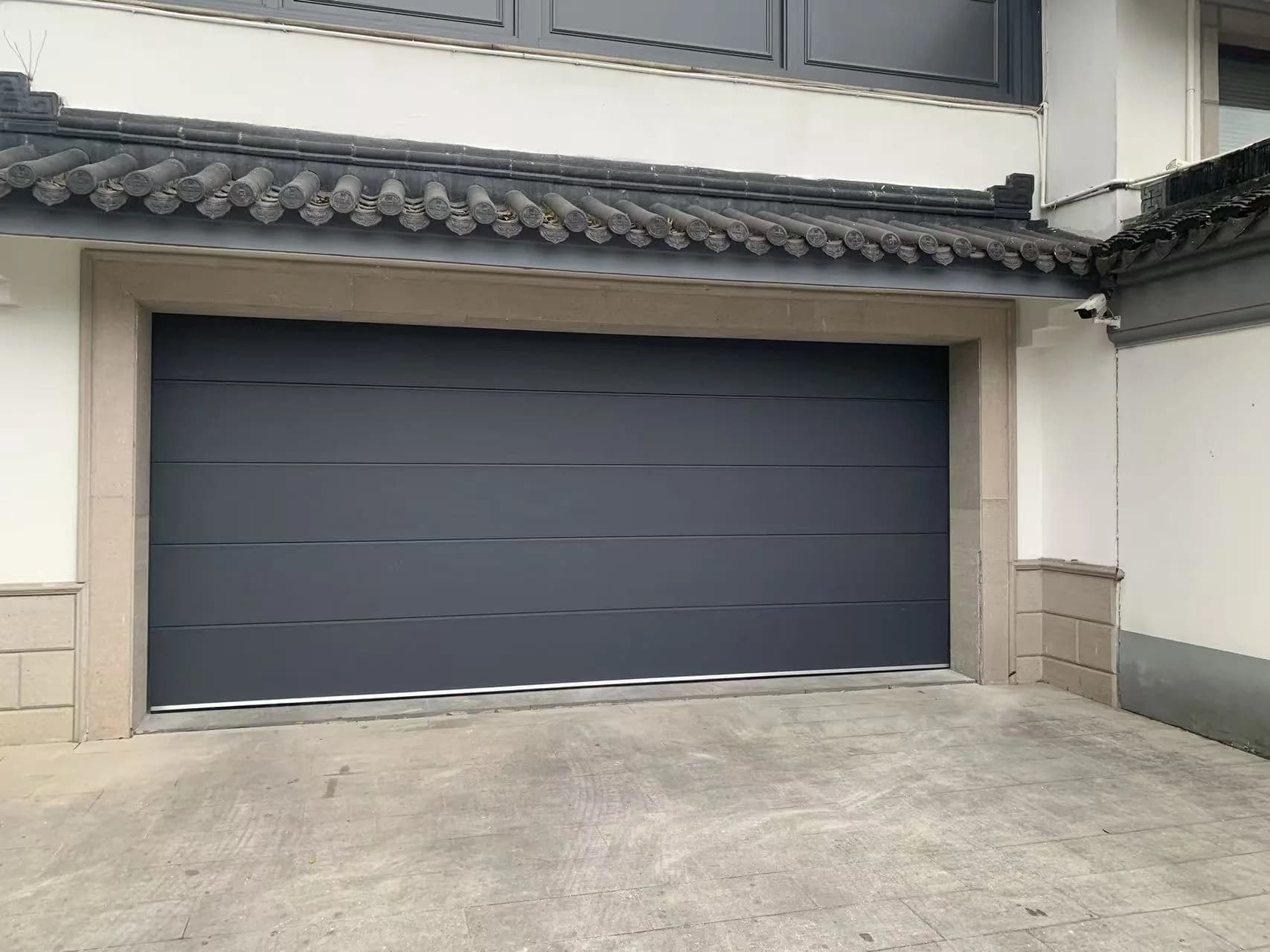 Rigid garage high-speed door integrated with a residential building